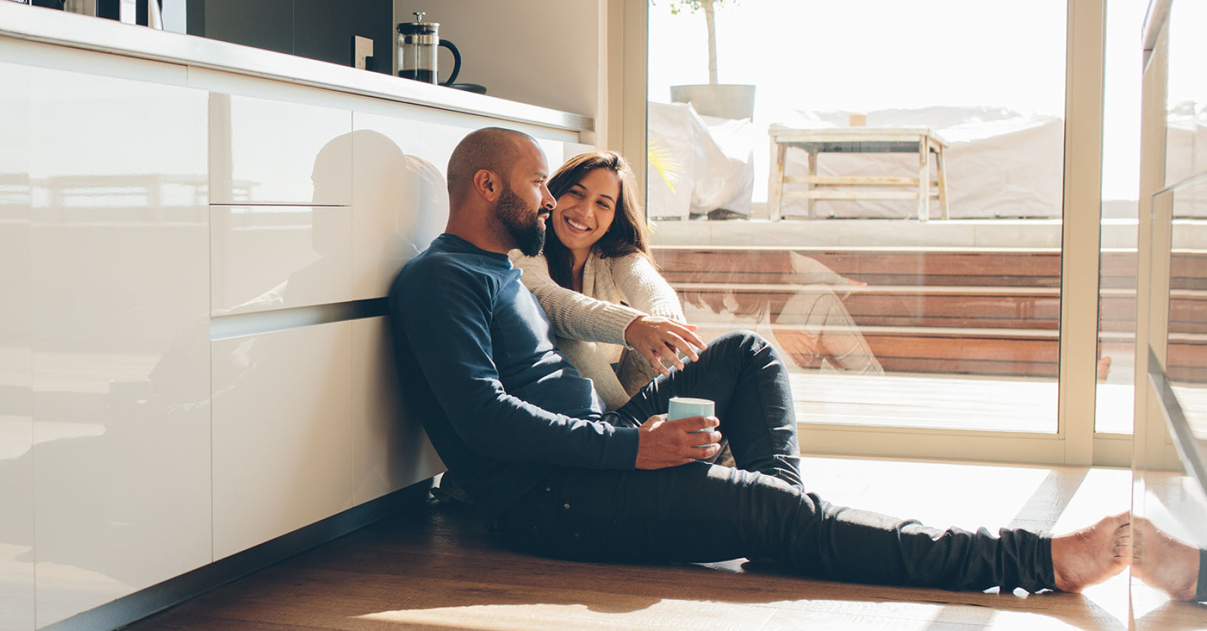 husband and wife sitting in kitchen 