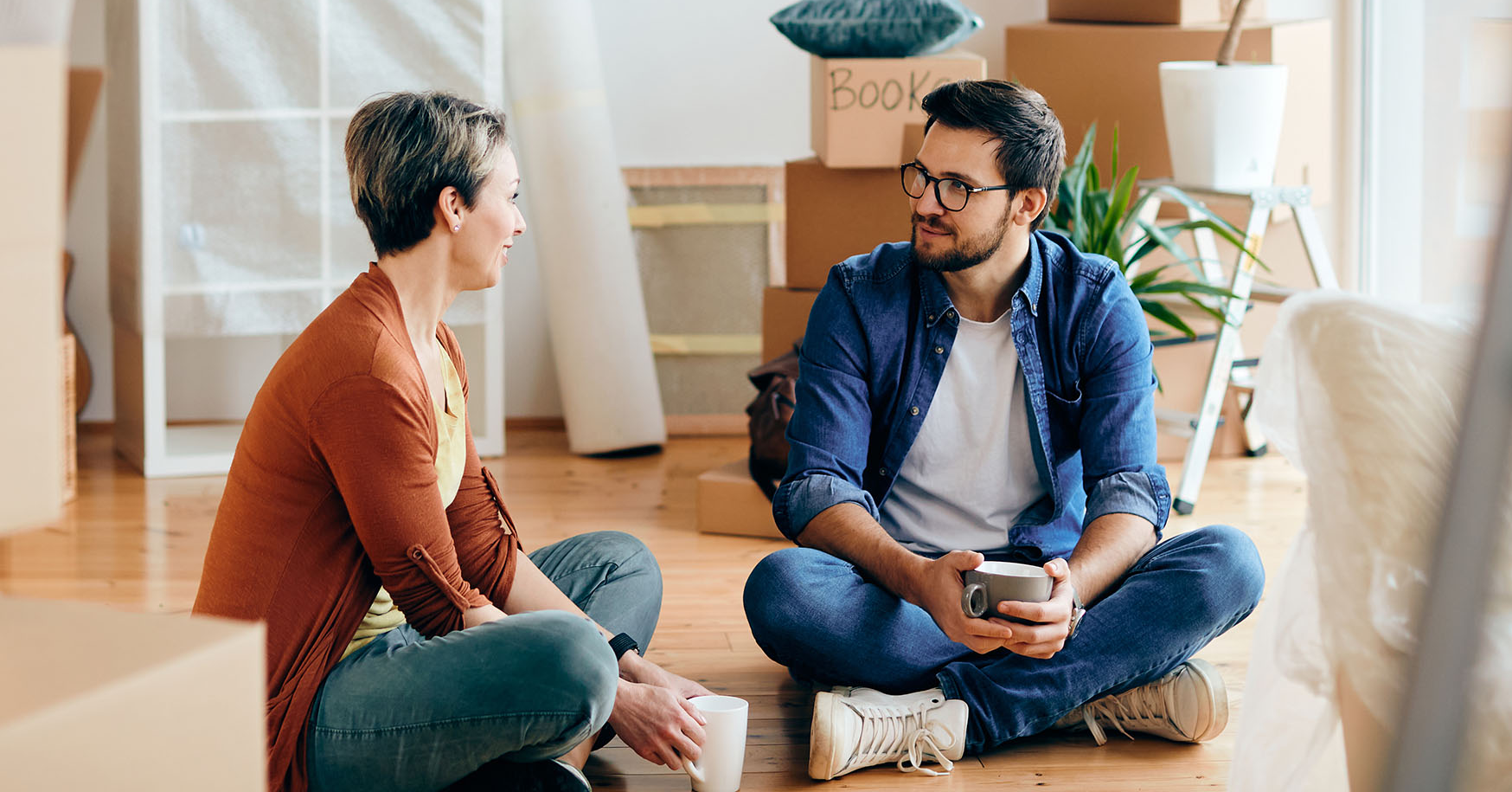 husband and wife sitting on floor talking