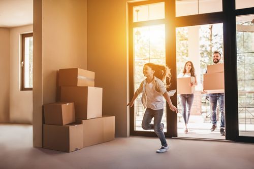 Happy family running into a home purchased with a conventional mortgage