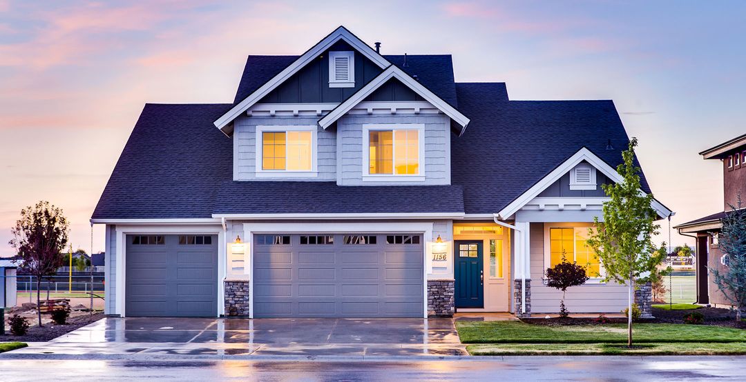 New construction home lit up at dawn