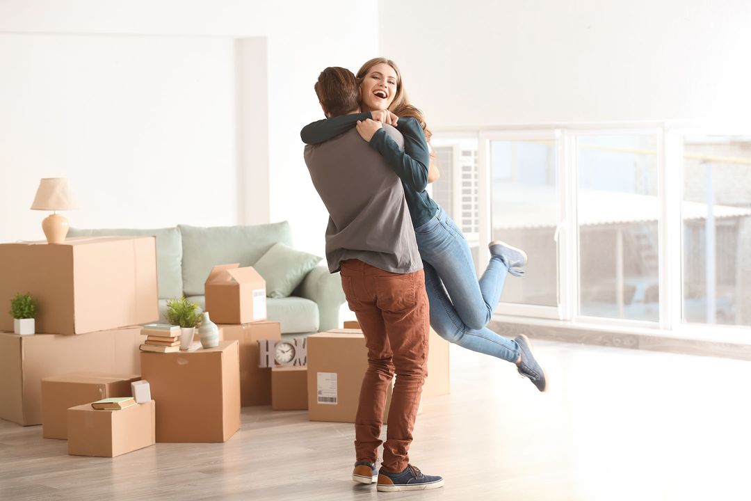 Happy Man and Wife Hugging After Purchasing New Home