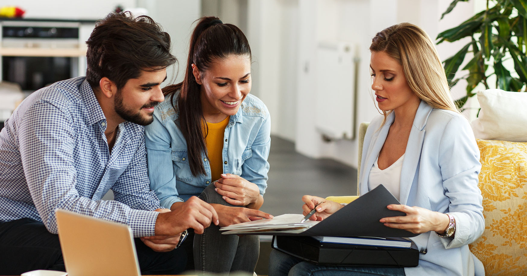 Agent explaining life insurance to young couple