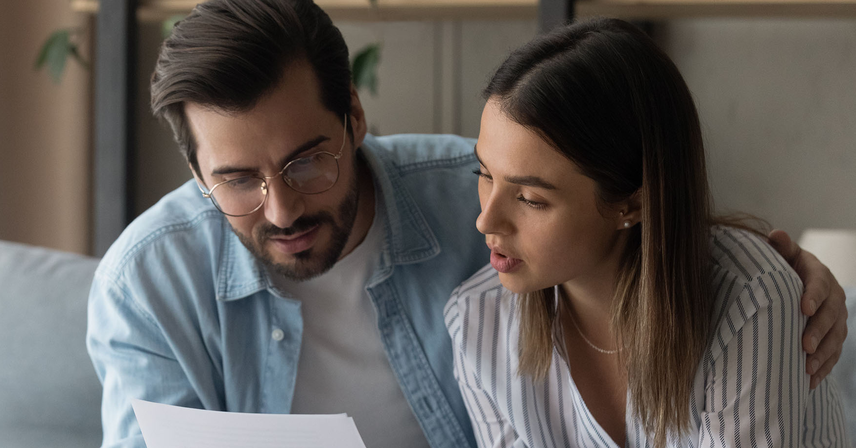 Husband and wife looking at market report