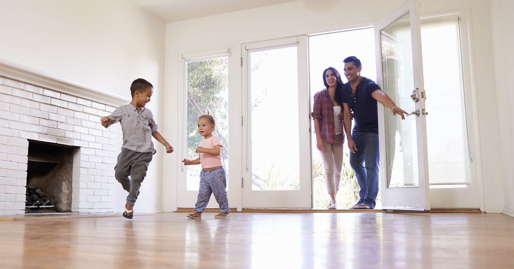 family walking into newly purchased home