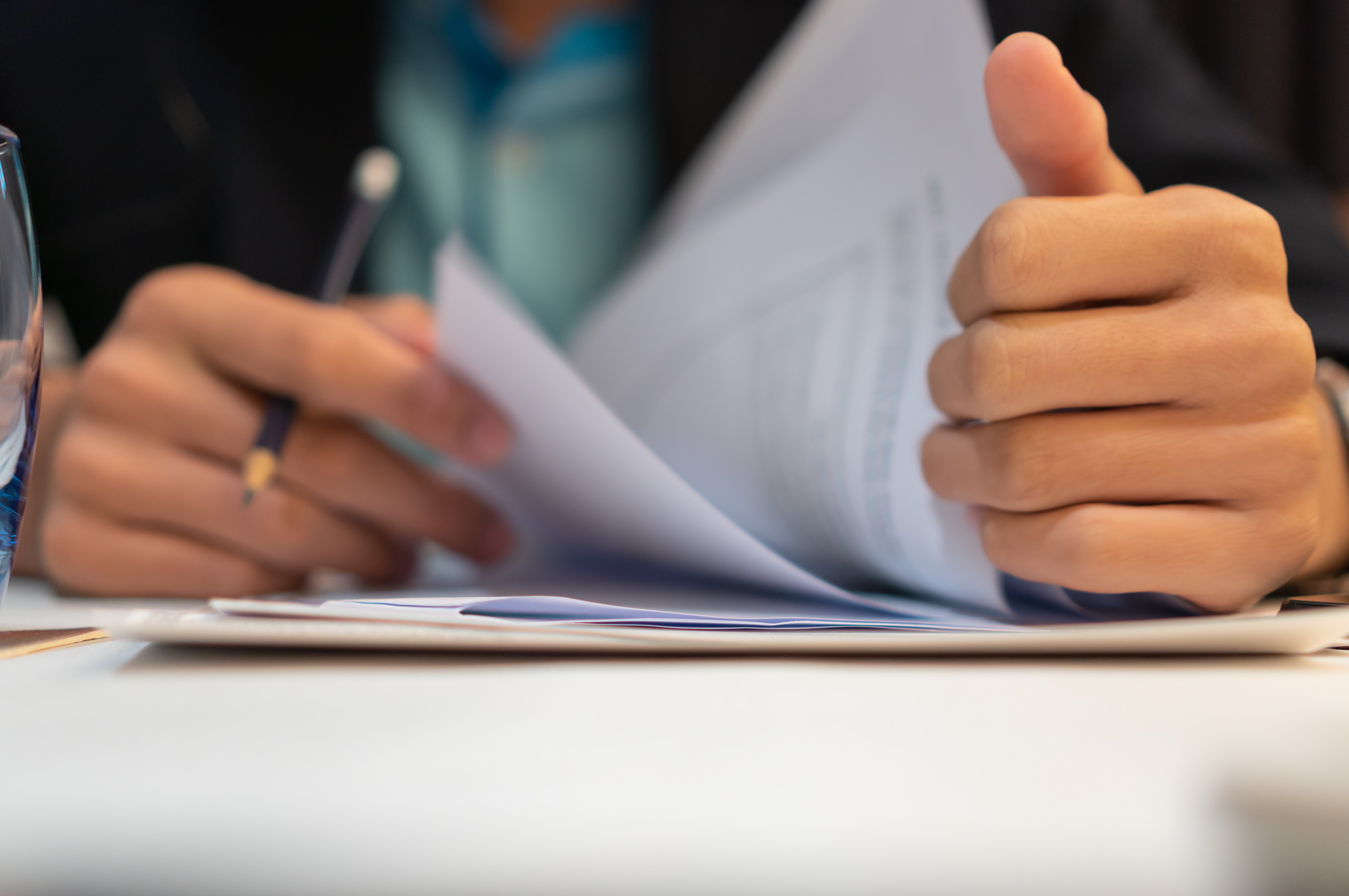 hands sorting through folder of documents