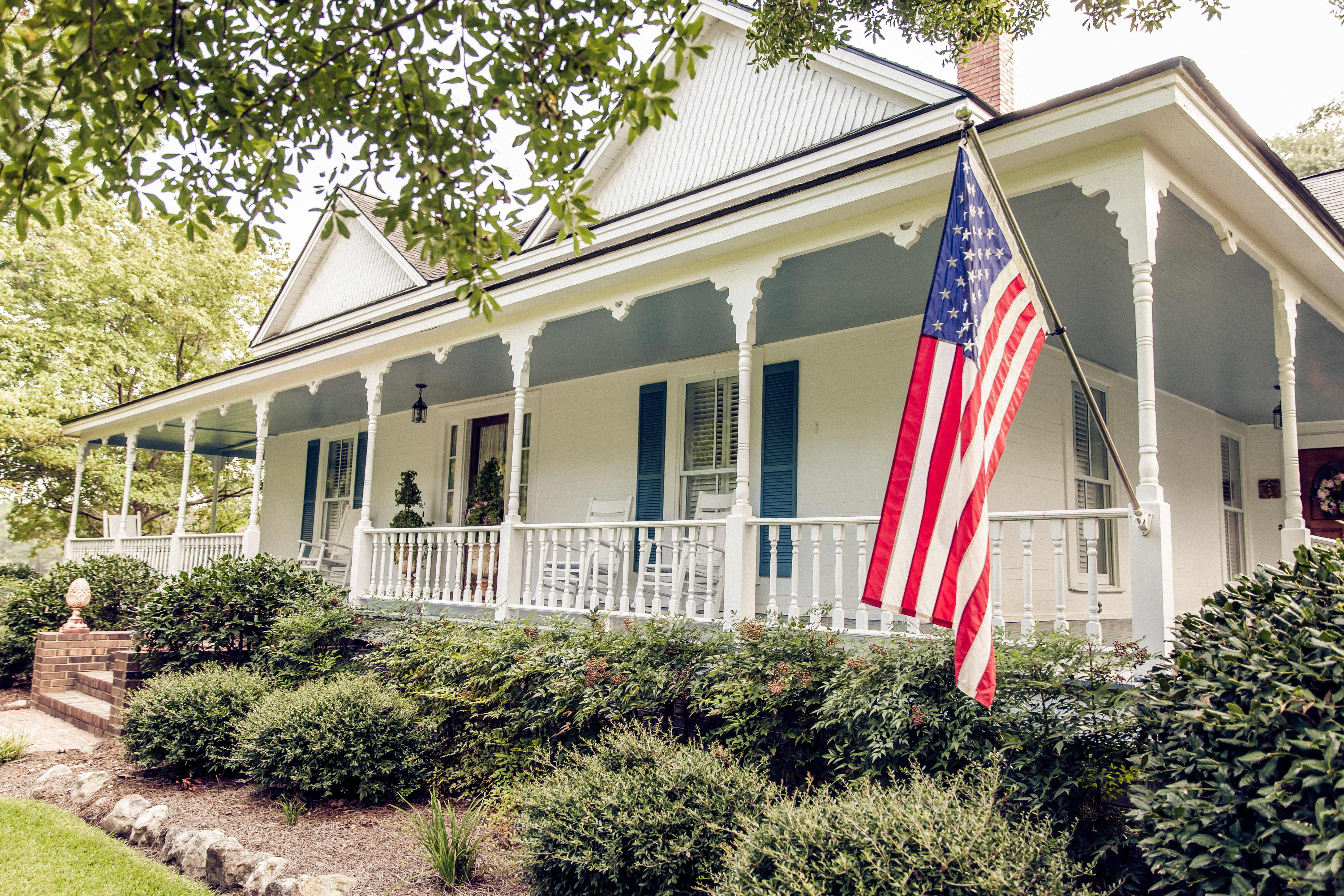 Flag hanging on front porch of home